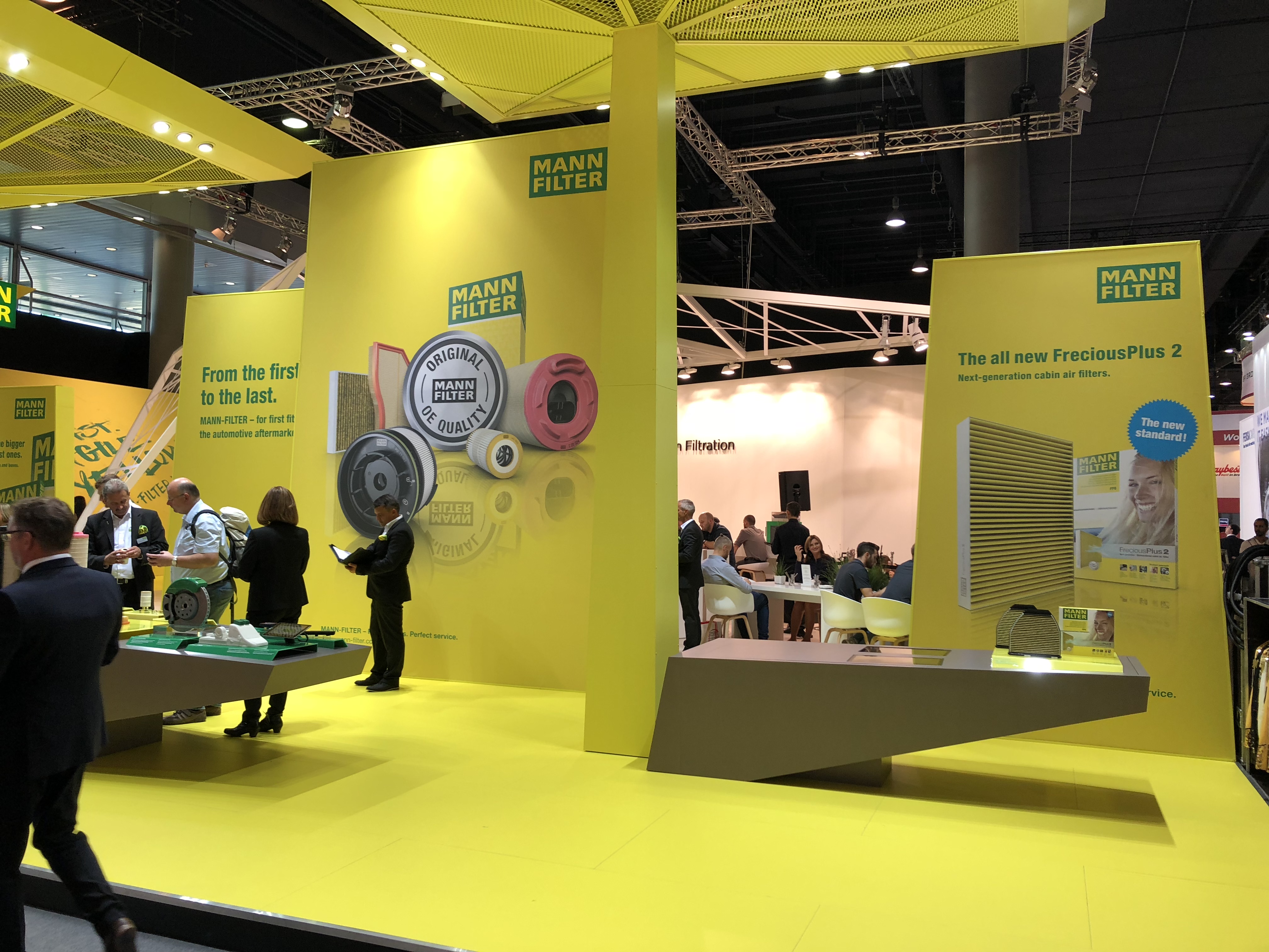 A yellow and green booth filled with people