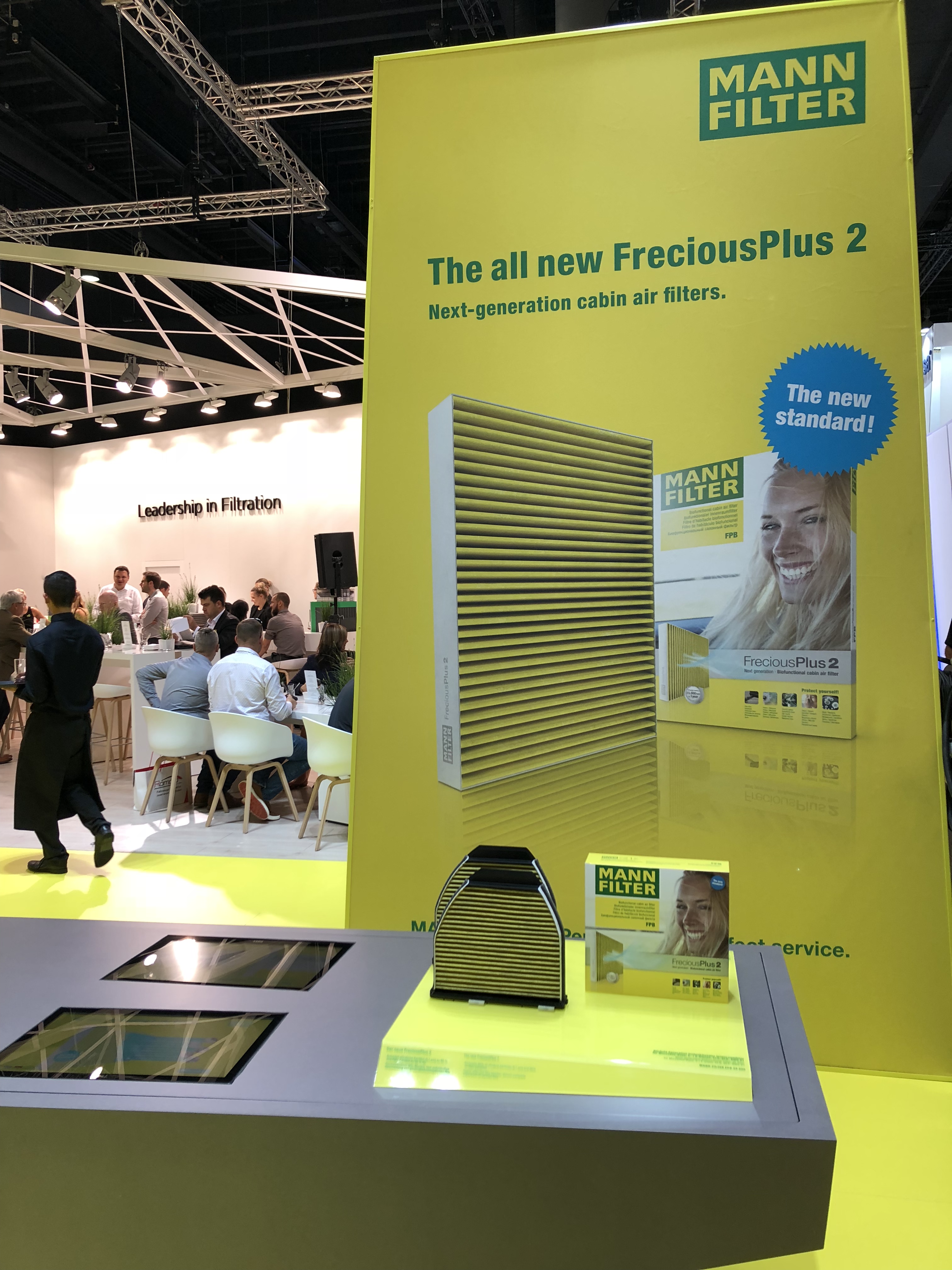 A yellow and green booth with a poster and a product